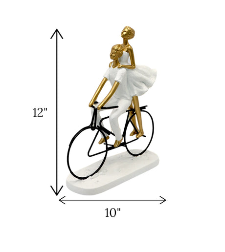 statue couple with cycle white & golden china